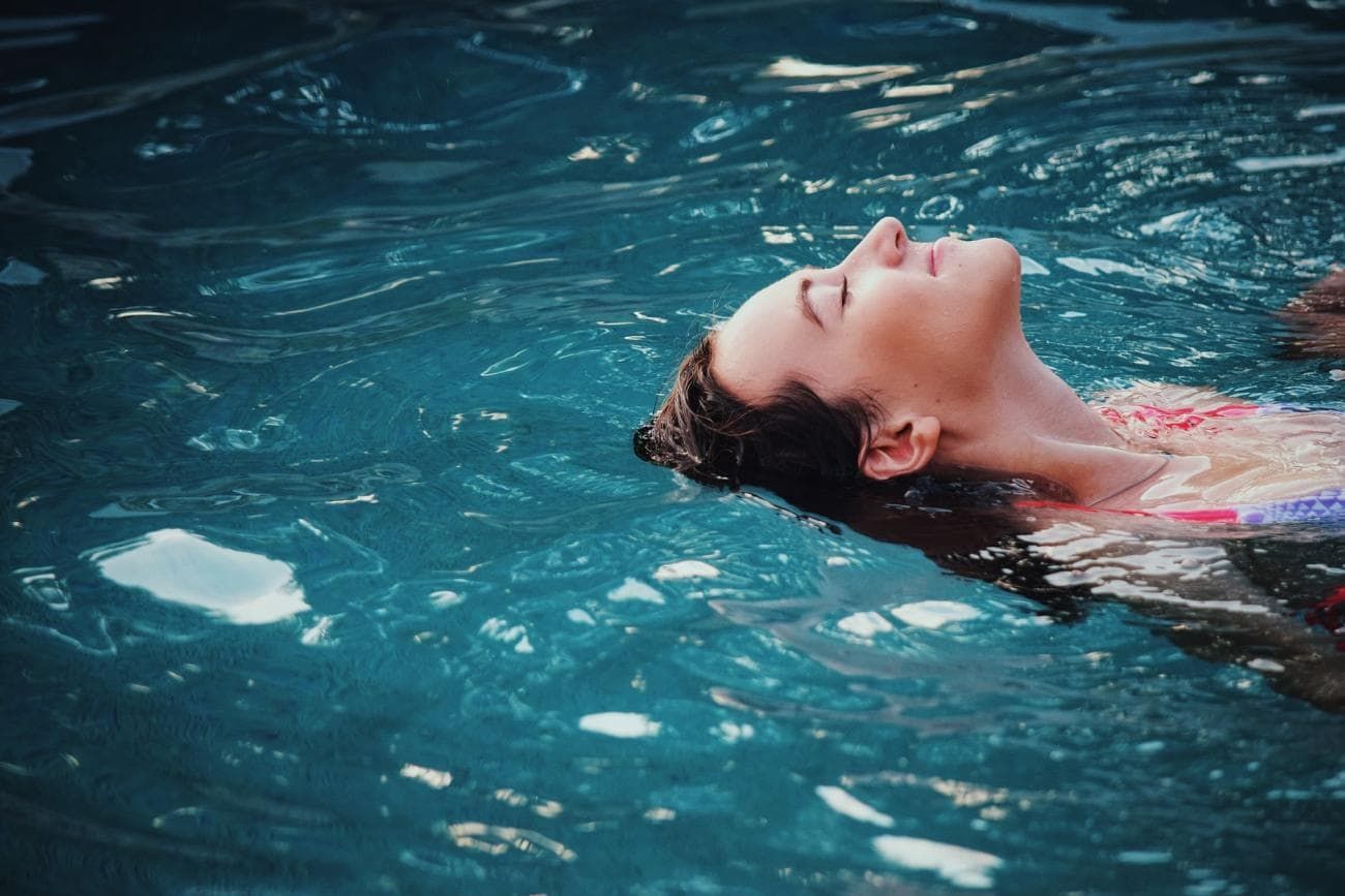 Woman lying in pool of water