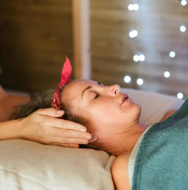 Woman receiving Reiki healing